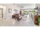 Cozy living room with tile floors, neutral furniture, and a view of the screened lanai at 9591 Sw 70Th Loop, Ocala, FL 34481