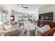 Living room with ample seating, a large TV, and an open layout to the dining area and kitchen at 9591 Sw 70Th Loop, Ocala, FL 34481