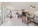 Bright and airy living room with white tile floors, open concept design, and comfortable seating arrangements at 9591 Sw 70Th Loop, Ocala, FL 34481