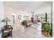 Open-concept living room with neutral tones, tile flooring, and sliding glass doors to the patio at 9591 Sw 70Th Loop, Ocala, FL 34481