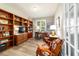 Office features built-in bookshelves and desk, complemented by two chairs, offering a cozy workspace at 9591 Sw 70Th Loop, Ocala, FL 34481