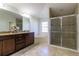 A primary bathroom features a shower, tub, vanity with double sinks, and tile floors at 9721 Sw 53Rd Ct, Ocala, FL 34476