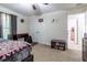 View of bedroom with ceiling fan and desk, leading to the closet and another room at 9721 Sw 53Rd Ct, Ocala, FL 34476