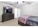 Bedroom with ceiling fan, neutral walls, and a dark wood dresser with TV at 9721 Sw 53Rd Ct, Ocala, FL 34476