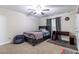 Bedroom with ceiling fan, gray walls, and a dark wood bed with bedding at 9721 Sw 53Rd Ct, Ocala, FL 34476