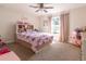 Bedroom with ceiling fan, neutral walls, and a light wood bed with bedding at 9721 Sw 53Rd Ct, Ocala, FL 34476