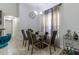 Elegant dining room with a glass-top table, upholstered chairs, and modern chandelier at 9721 Sw 53Rd Ct, Ocala, FL 34476