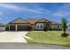 Lovely single-story home with a three-car garage, well-manicured lawn, and beautiful stone facade at 9721 Sw 53Rd Ct, Ocala, FL 34476