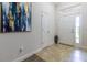 Inviting foyer with neutral tile flooring, transom window, and elegant artwork at 9721 Sw 53Rd Ct, Ocala, FL 34476