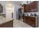 A kitchen featuring stainless steel appliances, granite countertops, and dark wood cabinets at 9721 Sw 53Rd Ct, Ocala, FL 34476