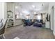 Spacious living room featuring plush carpet, recessed lighting, and a stylish sectional sofa at 9721 Sw 53Rd Ct, Ocala, FL 34476