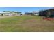 View of a backyard with a green lawn between two houses with screened in patios at 9764 Sw 81St Ln, Ocala, FL 34481