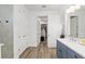 Well-lit bathroom with wood-look flooring, a double vanity, and a walk-in closet nearby at 9764 Sw 81St Ln, Ocala, FL 34481