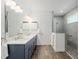 Stylish bathroom featuring a double vanity, modern fixtures, and a glass-enclosed shower at 9764 Sw 81St Ln, Ocala, FL 34481