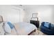 Bedroom with a wood bed frame, dark dresser, and a blue accent chair for relaxing at 9764 Sw 81St Ln, Ocala, FL 34481