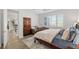 Bedroom featuring a seating area, carved bed frame, wood-style floors, and plantation shutters at 9764 Sw 81St Ln, Ocala, FL 34481