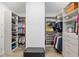 Spacious walk-in closet with custom shelving, drawers, and ample hanging space at 9764 Sw 81St Ln, Ocala, FL 34481