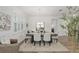 Bright dining room featuring a long table with seating for six and a view of the home's interior at 9764 Sw 81St Ln, Ocala, FL 34481