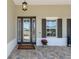 Elegant front entrance featuring a decorative door, stylish windows, and stone-paved flooring at 9764 Sw 81St Ln, Ocala, FL 34481