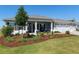 Single-story home featuring a well-manicured lawn, welcoming porch, and three-car garage at 9764 Sw 81St Ln, Ocala, FL 34481