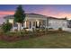 Beautiful single-story home with a welcoming front porch and well-manicured lawn at sunset at 9764 Sw 81St Ln, Ocala, FL 34481