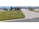 Well-manicured front yard with paved driveway leading to a charming home with a two-car garage at 9764 Sw 81St Ln, Ocala, FL 34481