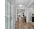 Bright foyer with hardwood floors, a view of the open-concept living area, and a glass-paneled door at 9764 Sw 81St Ln, Ocala, FL 34481