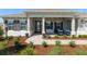 Inviting front porch with stylish seating, elegant lighting, and manicured landscaping at 9764 Sw 81St Ln, Ocala, FL 34481