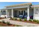 Inviting front porch with stylish seating, elegant lighting, and manicured landscaping at 9764 Sw 81St Ln, Ocala, FL 34481