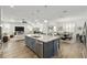 Open floor plan showcasing kitchen island with stainless steel appliances and dining/living area with ample natural light at 9764 Sw 81St Ln, Ocala, FL 34481