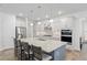 Well-lit kitchen featuring stainless steel appliances, white cabinets, and a large island with seating at 9764 Sw 81St Ln, Ocala, FL 34481