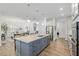 Bright kitchen island with seating, views of the dining room and living room, and modern appliances at 9764 Sw 81St Ln, Ocala, FL 34481
