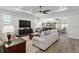 Spacious living room featuring hardwood floors, recessed lighting, and a comfortable seating area at 9764 Sw 81St Ln, Ocala, FL 34481