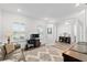 Bright living room with comfortable seating, natural light, and an adjacent office space at 9764 Sw 81St Ln, Ocala, FL 34481
