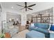 Open concept living room with hardwood floors, comfortable furniture, and a view into the dining area at 9764 Sw 81St Ln, Ocala, FL 34481