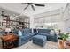 Comfortable living room with hardwood floors, large windows, and a blue sectional sofa at 9764 Sw 81St Ln, Ocala, FL 34481