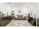 Comfortable living room featuring a cozy couch, decorative rug, and a well-lit workspace at 9764 Sw 81St Ln, Ocala, FL 34481
