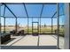 Spacious screened-in patio with outdoor seating, perfect for enjoying the view of the manicured yard at 9764 Sw 81St Ln, Ocala, FL 34481
