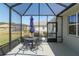 Screened-in patio with outdoor dining set and grilling area, perfect for entertaining guests at 9764 Sw 81St Ln, Ocala, FL 34481