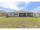 Grassy backyard with covered patio and well kept lawn at 9945 Sw 83Rd Ln, Ocala, FL 34481