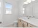 Well lit bathroom featuring modern vanity with quartz countertop and a framed mirror at 9945 Sw 83Rd Ln, Ocala, FL 34481