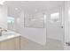 A bright bathroom features a glass enclosed shower and a modern vanity at 9945 Sw 83Rd Ln, Ocala, FL 34481