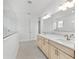 A modern bathroom features double sinks, a large mirror, and a glass shower at 9945 Sw 83Rd Ln, Ocala, FL 34481