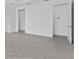 A spacious bedroom features gray tiled floor with a view to the ensuite bathroom at 9945 Sw 83Rd Ln, Ocala, FL 34481