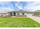 Beautiful single-story home featuring an attached two car garage and a paved driveway at 9945 Sw 83Rd Ln, Ocala, FL 34481