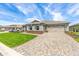 Beautiful single-story home featuring an attached two car garage and a paved driveway at 9945 Sw 83Rd Ln, Ocala, FL 34481