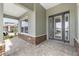 Inviting front porch with stone accents and an elegant front door with decorative glass at 9945 Sw 83Rd Ln, Ocala, FL 34481