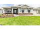Charming single-story home features a stone accent base, well-maintained lawn, and welcoming walkway at 9945 Sw 83Rd Ln, Ocala, FL 34481