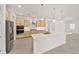 Modern kitchen featuring stainless steel appliances, light wood cabinets, and oversized island at 9945 Sw 83Rd Ln, Ocala, FL 34481