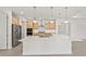 Modern kitchen features wood cabinetry, stainless appliances, and white countertop island at 9945 Sw 83Rd Ln, Ocala, FL 34481